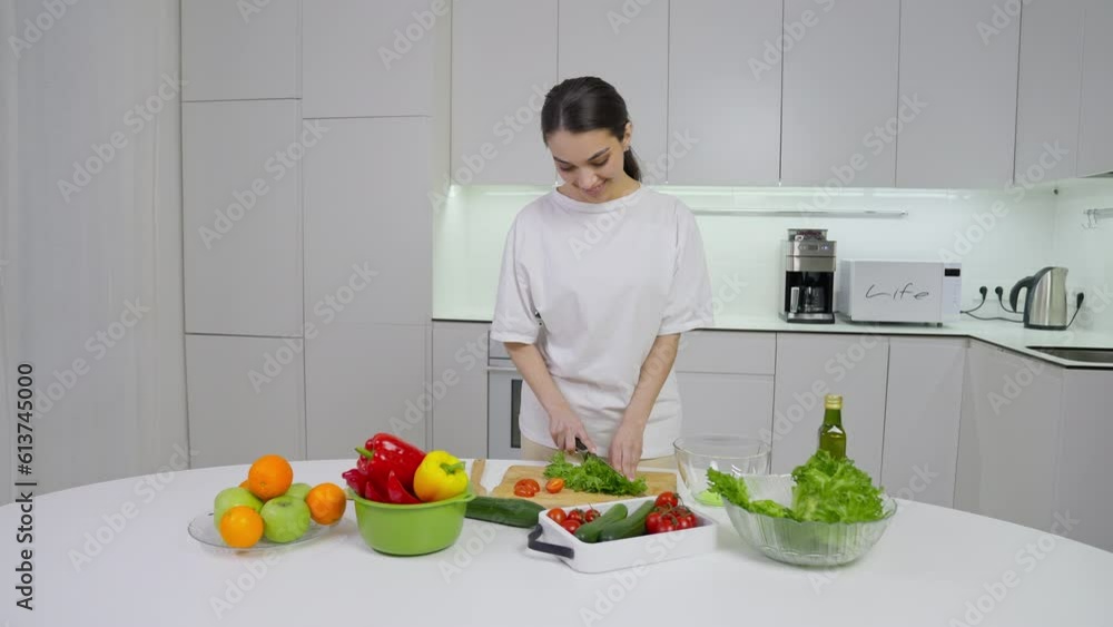 Girl makes salad for dinner from natural products Girl makes salad for dinner from natural products