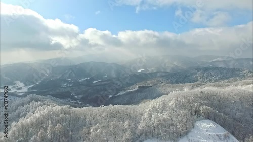 Wallpaper Mural High aerial view above a snow covered winter valley surrounded by mountains. Torontodigital.ca