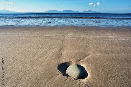 Stone on Newborough beach, Anglesey, Wales, United Kingdom, Europe. A lonely stone on a sandy beach.  photo