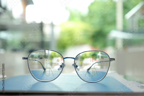glasses on the street, Eyeglasses on table, progressive lenses, eyeglasses for the elderly, glasses progressive lens, eyeglass progressive lens, close-up of glasses on lenses test, looking through gla