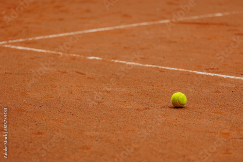 tennis court covered with red clay for championship or sports competition. tournament for athletes. healthy lifestyle workout fitness. warm-up. Yellow balls and rackets on ground. place for text © MyJuly