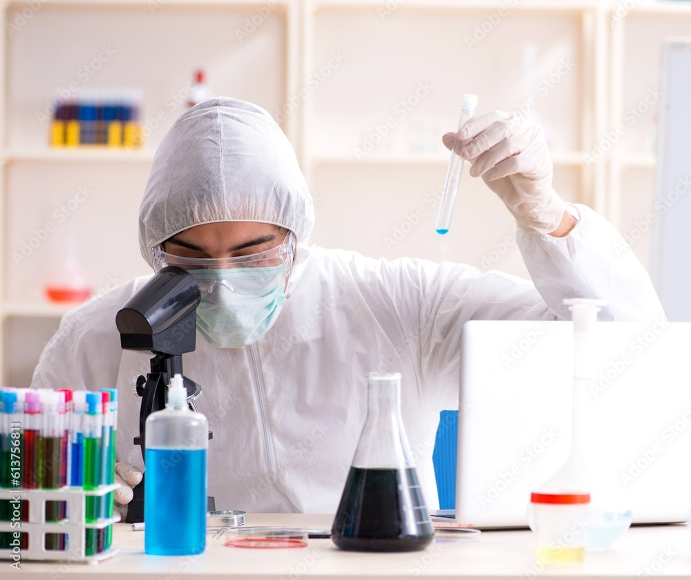 Young handsome chemist working in the lab Young handsome chemist working in the lab