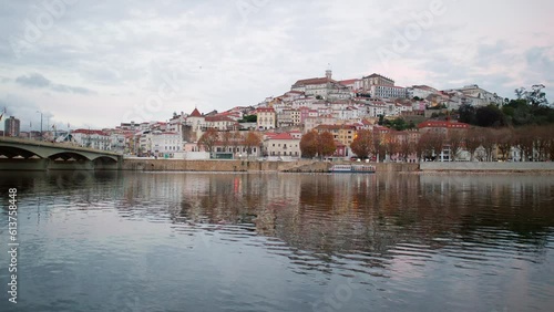 Coimbra historic old city reflecting in the Mondego river. Portugal