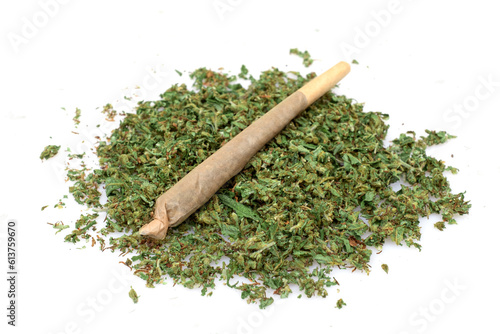 Pre rolled marijuana together with chopped cannabis buds on white background