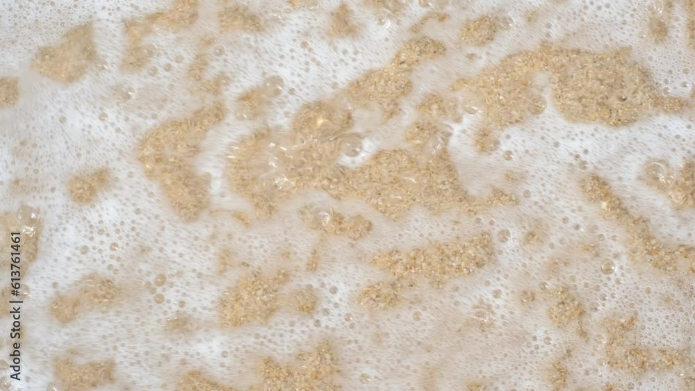 Female hand draws on sand question mark, top view. Female hand draws on sand question mark, top view.