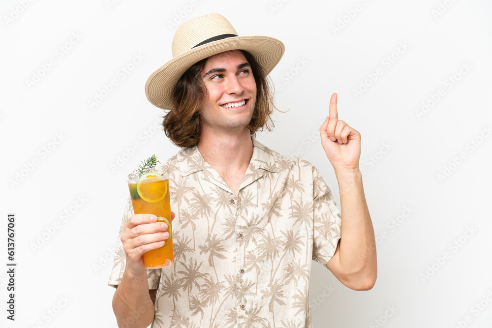 Young handsome man holding a cocktail isolated on white background pointing up a great idea Young handsome man holding a cocktail isolated on white background pointing up a great idea