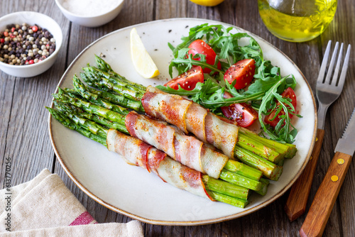 Asparagus baked with bacon and arugula and tomato salad. Healthy eating. Diet.