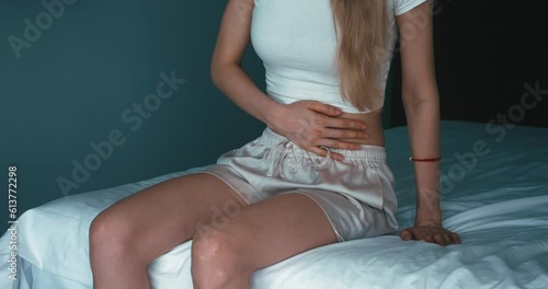 Caucasian female have abdominal pain, indigestion, gastritis, menstrual cramps, flatulence, diarrhea, distention, belly inflammation problem, suffer food poisoning. Close-up shot