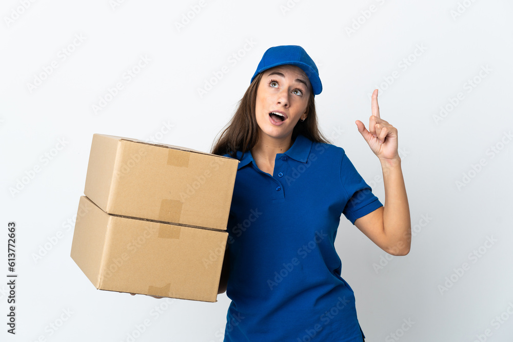 Young delivery woman over isolated white background pointing up and surprised