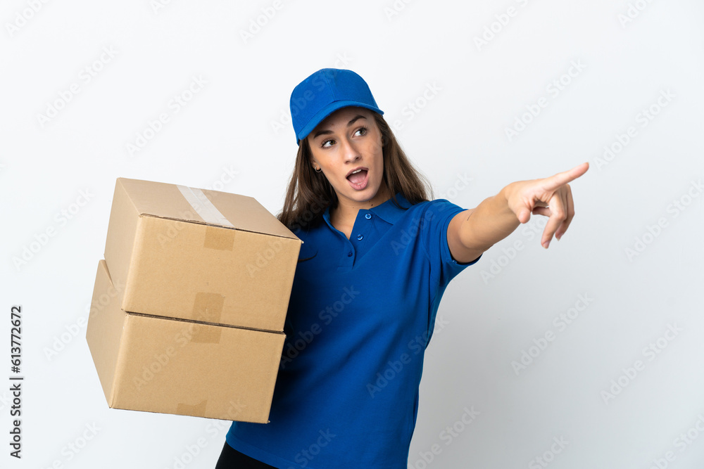 Young delivery woman over isolated white background pointing away Young delivery woman over isolated white background pointing away