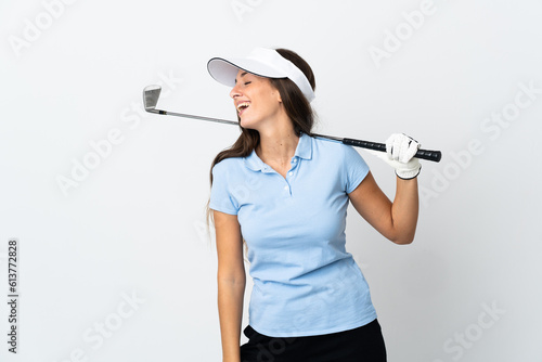 Young golfer woman over isolated white background laughing in lateral position © luismolinero