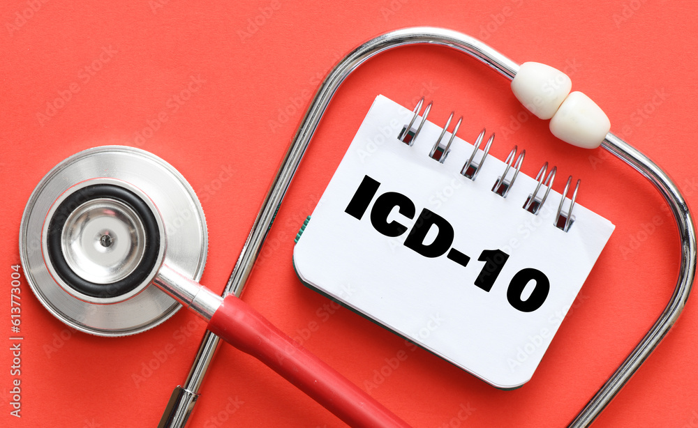 Concept of ICD10 in a notebook on a red table next to a stethoscope