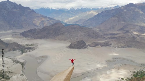 A tourist man climbing Marsur Rock cliff in Karakoram high mountain hills. Nature landscape background, Skardu-Gilgit, Pakistan. Travel on holiday vacation. People lifestyle