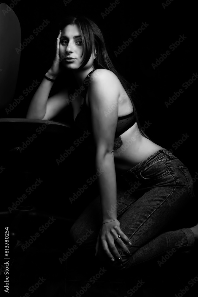 Black and white photo of a young girl on a black background. Black and white photo of a young girl on a black background.