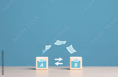 Data Synchronize Transfer, Copy or Move data files between folders, Backup sync data, Exchange files in folder, Send documents to internet. Wooden blocks with virtual document load to another folder. photo