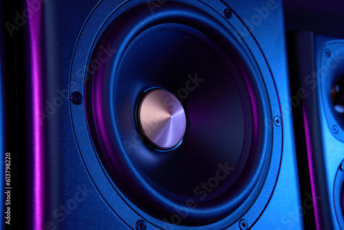 Multimedia acoustic sound speaker with neon lighting. Sound audio system on dark background.