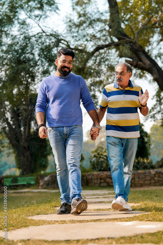 Old indian father with his young son spending time at park. Old indian father with his young son spending time at park.