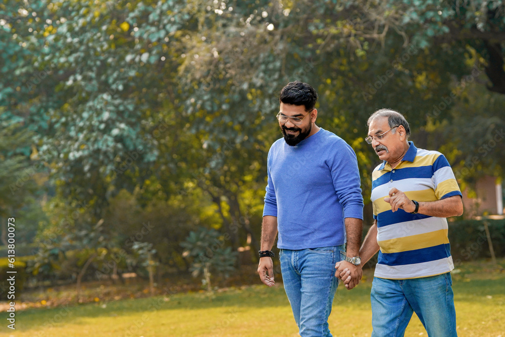 Old indian father with his young son spending time at park. Old indian father with his young son spending time at park.