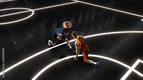Aerial view of professional two basketball players in action with basketball ball at 3d model sports arena.