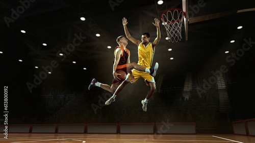 Block. Professional two basketball players in action with basketball ball at 3d model sports arena. © Lustre