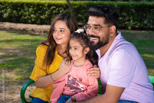 Happy indian couple with his little girl at garden. © Niks Ads