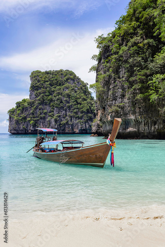 Traditional longtail boat with beautiful scenery view at Maya Bay on Phi Phi Leh Island in sunshine day.