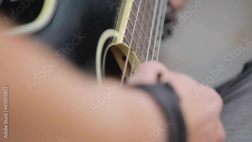 Close up of acoustic guitar playing, strumming sides