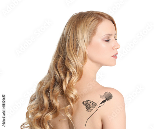 Young woman with beautiful tattoo of flower and butterfly on white background, back view