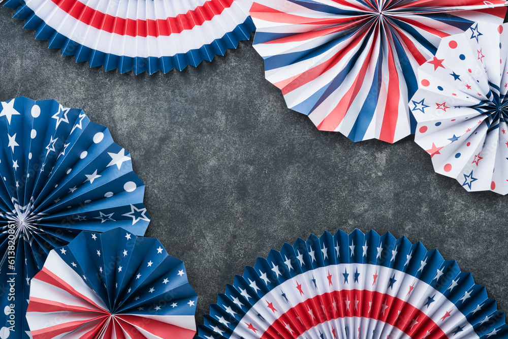 Obraz premium 4th of July background. USA paper fans, Red, blue, white stars, balloons, gold confetti on gray dark concrete background. Happy Labor, Independence or Presidents Day. American flag colors. Top view.