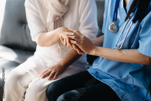 medical doctor holing patient's hands and comforting her.Kind doctor giving real support for patient...