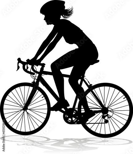 Bicyclist riding their bike and wearing a safety helmet in silhouette