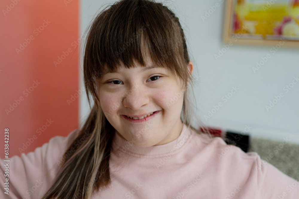 Sunny smiling girl close-up portrait World day of people with down syndrome Sunny smiling girl close-up portrait World day of people with down syndrome