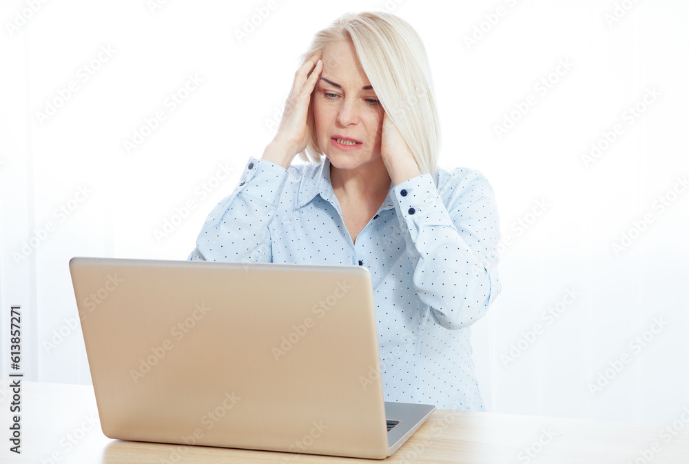 Tired upset mature old businesswoman suffering from strong chronic headache migraine or memory loss at work, stressed dizzy fatigued middle aged senior woman office worker feels pain in aching head Tired upset mature old businesswoman suffering from strong chronic headache migraine or memory loss at work, stressed dizzy fatigued middle aged senior woman office worker feels pain in aching head