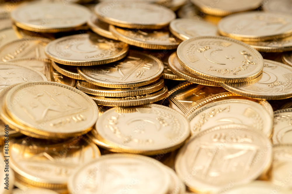 Stacks of gold coins of Pakistani currency symbolize wealth and prosperity Stacks of gold coins of Pakistani currency symbolize wealth and prosperity