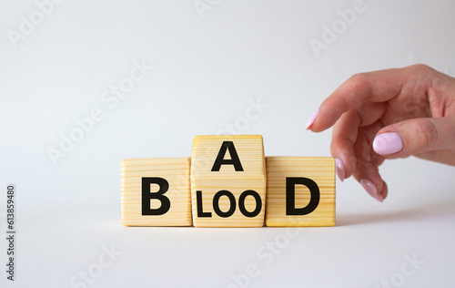 Breed Bad Blood symbol. Businessman hand turns wooden cubes with words Breed Bad Blood. Beautiful white background. Breed Bad Blood and business concept. Copy space