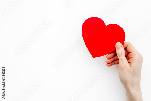 Red heart in female hands. Valentines day or health care concept