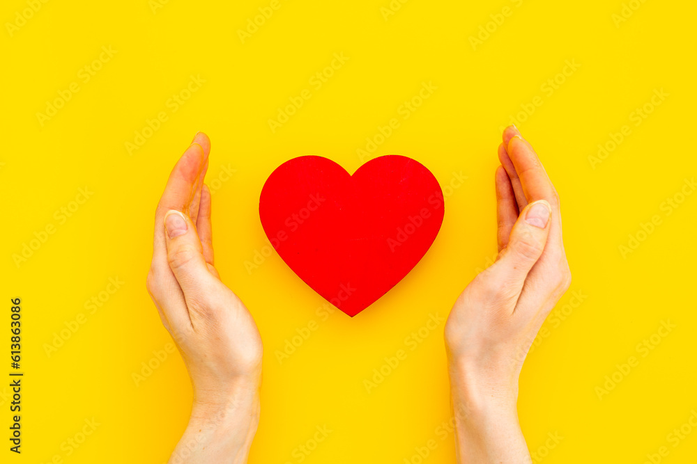 Red heart with woman hands, top view. Health care and love concept Red heart with woman hands, top view. Health care and love concept
