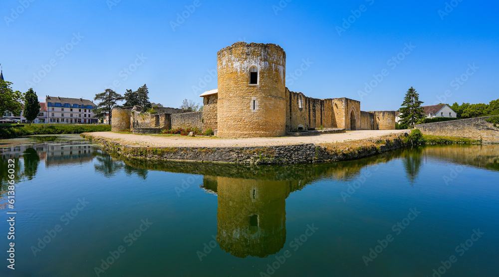 Reflection of the round corner tower of the medieval castle of Brie Comte Robert in the water-filled moat in the French department of Seine et Marne in the capital region of Ile-de-France near Paris - obrazy, fototapety, plakaty 
