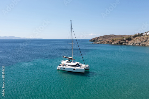 Sailing boat catamaran on rippled sea, rocky shore, summer vacation, Greek island Greece © Rawf8