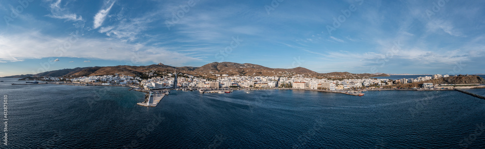 Tinos island Hora town Cyclades Greece. Aerial drone panoramic view of harbor, sea blue sky. Banner