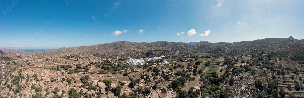 Greece. Tinos island Cyclades. Aerial panoramic view of Volax village, granite stone background.