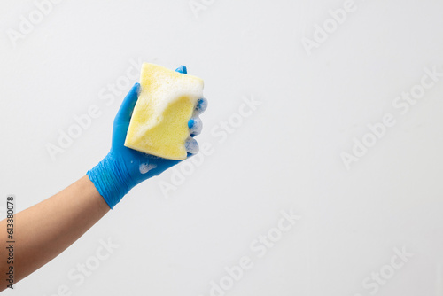 Put on gloves and hold a sponge to clean.