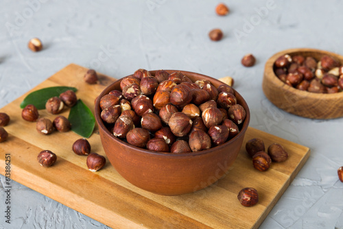 Wooden bowl full of hazelnuts on table background. Healthy eating concept. Super foods photo