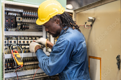 Electrical technician tests wiring, polarity, grounding, voltages and performs electrical maintenance using hand tools that involve clamp meter, screwdriver, and cutter. The foreman's routine tasks.