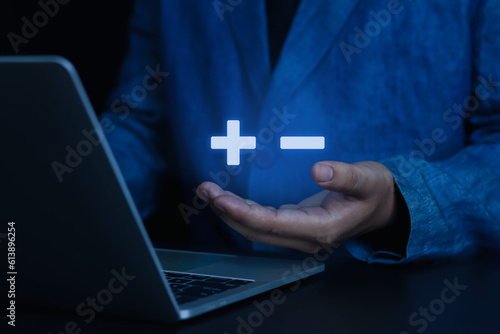 Wallpaper Mural Businessman showing plus and minus signs with positive or negative business decisions, comparative analysis of advantages and disadvantages. Torontodigital.ca