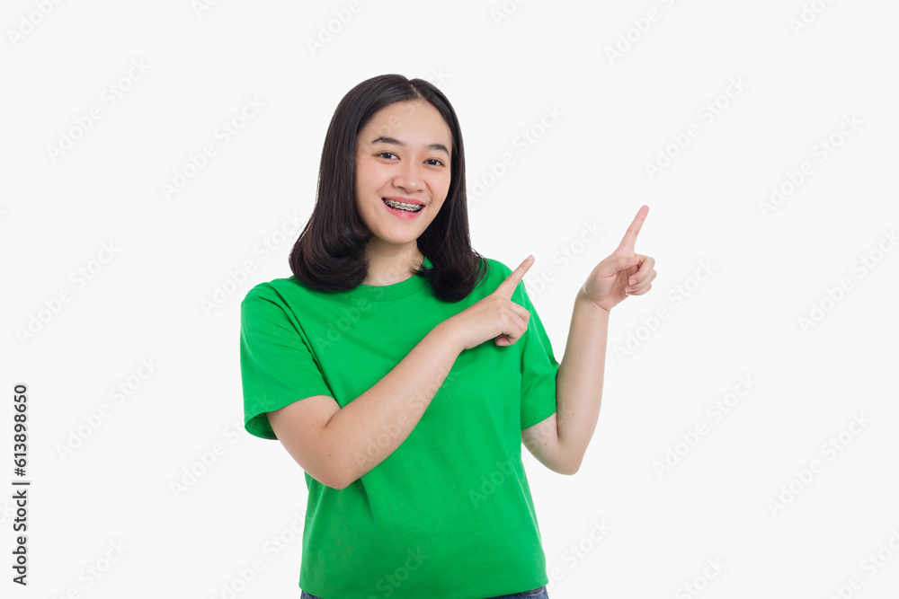 Cheerful excited asian woman pointing finger to the left Cheerful excited asian woman pointing finger to the left
