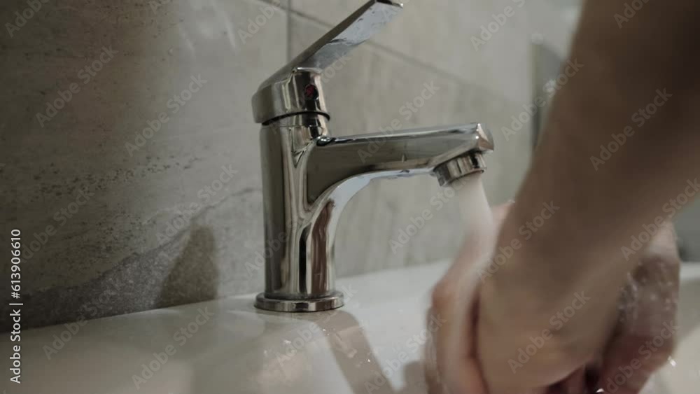 Washing hands under the tap in the bathroom after using the toilet. Hand hygiene, protection