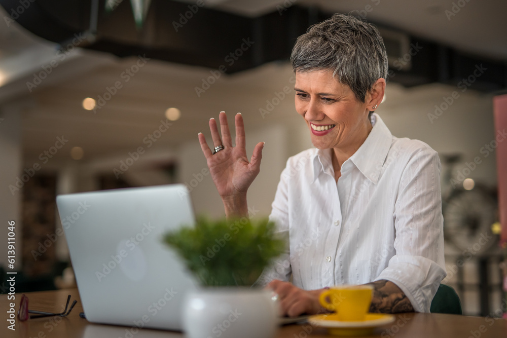 One senior business woman working on laptop and making a conference video call, modern business and lifestyle concept One senior business woman working on laptop and making a conference video call, modern business and lifestyle concept