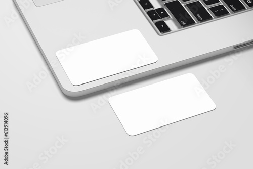 Business Card Mockup over a Laptop keyboard on a White background
