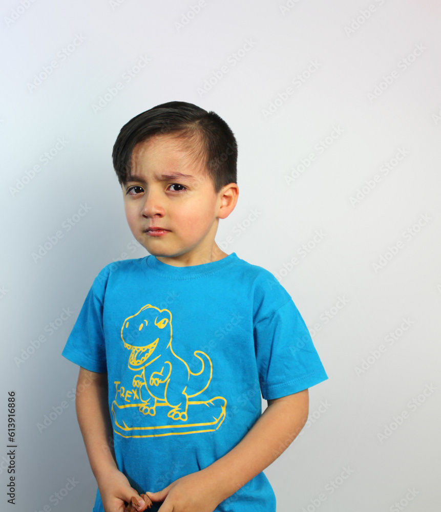 Sad and Angry kid, looking sideways, about to cry, 5 year-old boy, feelings, emotion, unhappy, latin boy, light skin, medium shot, black hair, white background, body three-quarter view, blue t-shirt Sad and Angry kid, looking sideways, about to cry, 5 year-old boy, feelings, emotion, unhappy, latin boy, light skin, medium shot, black hair, white background, body three-quarter view, blue t-shirt